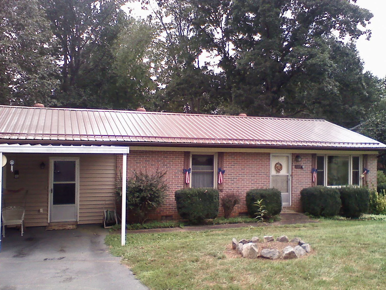 Bronze metal roof and carport on a brick ranch home — Roof Repair work by our crew in Salt Point