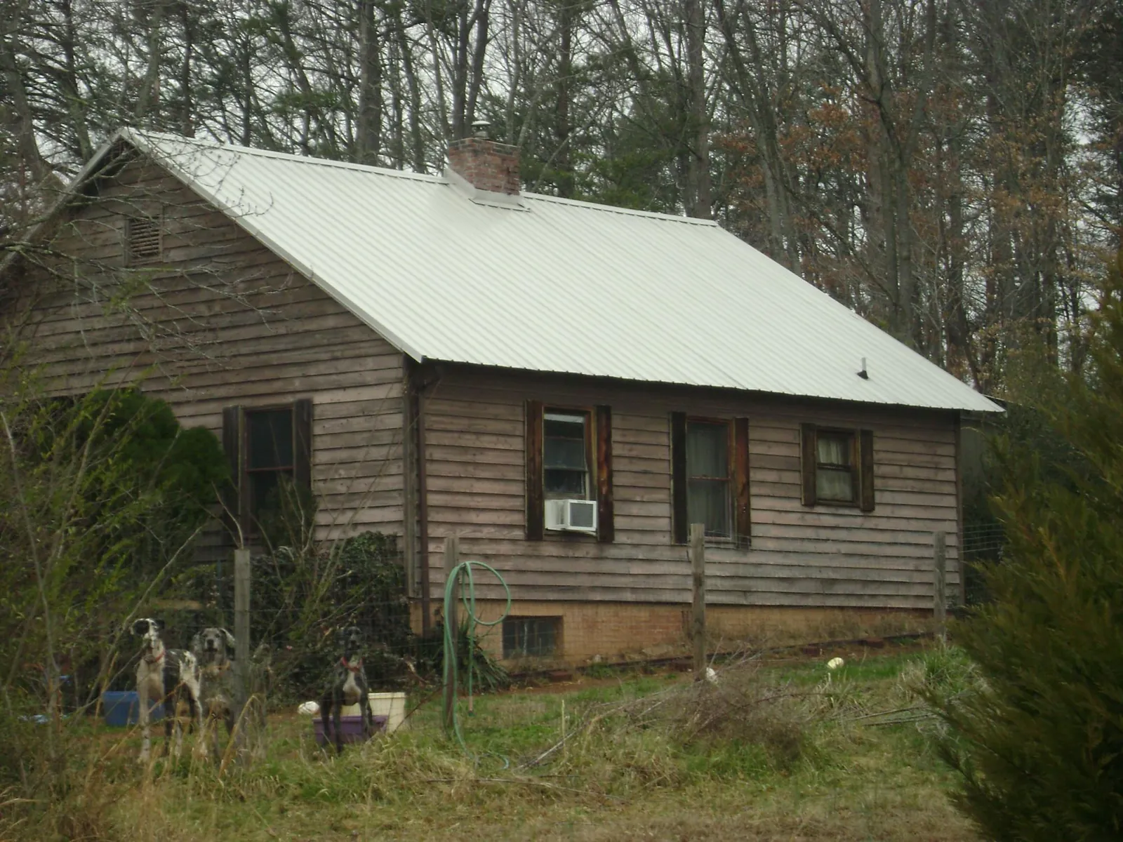 White metal roof on an old wood sided farmhouse, from a Metal Roof Installation job in Salt Point